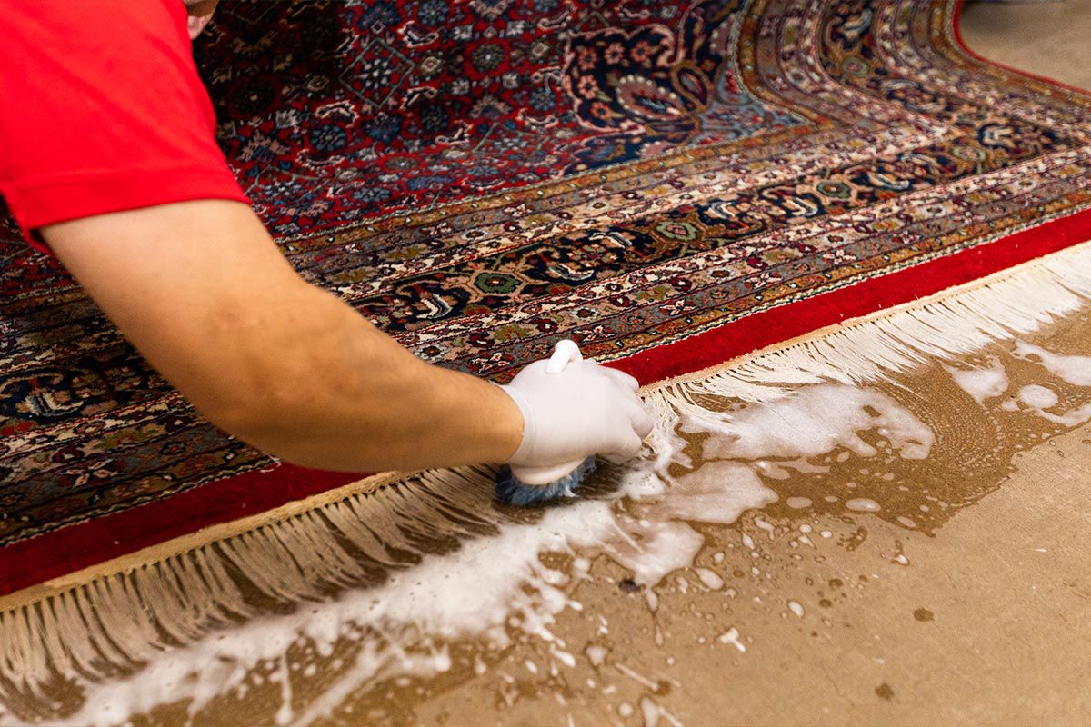 Man brushing rug